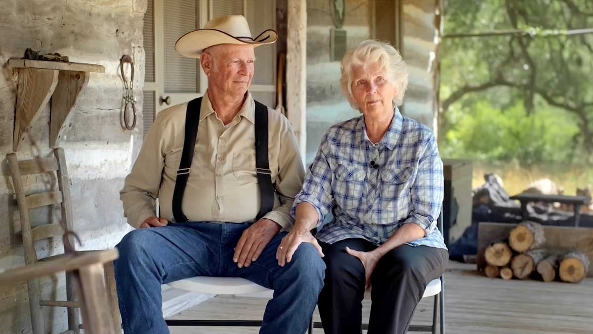 Photo of Mike and Karen Collins sitting on the porch of their home