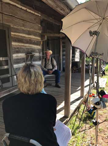 Photos of Olive interviewing Mike Collins on the porch of his home