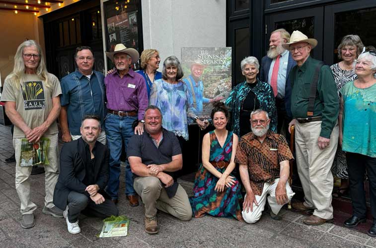 Gault Site experts and production team members around the new movie poster at the film's premier